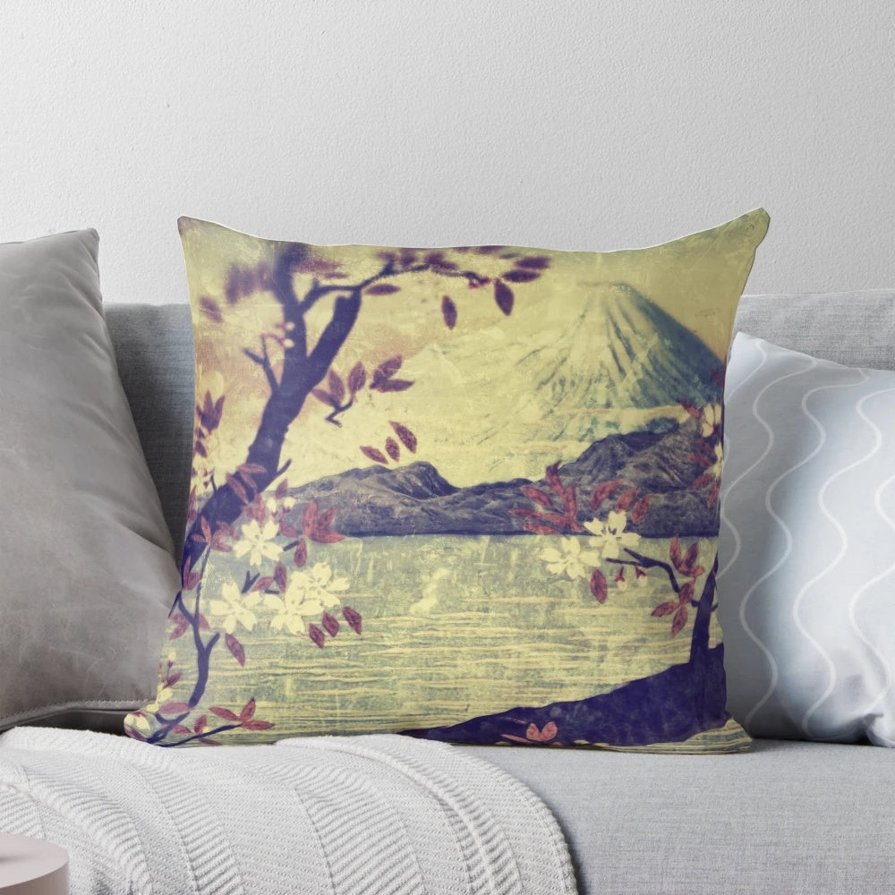 A decorative pillow featuring a serene Japanese landscape with Mount Fuji, a mountain lake, and delicate flowers.