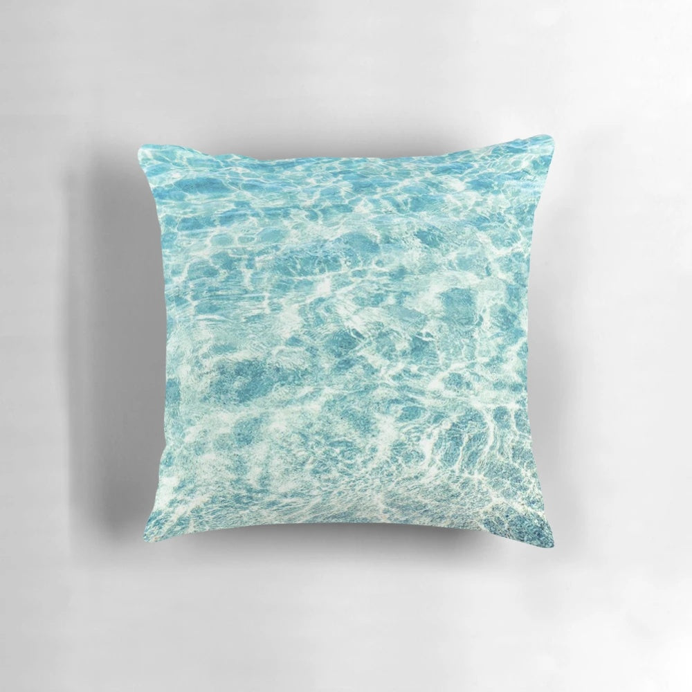 A plush, blue water-themed pillow that invites you to escape to a tropical paradise