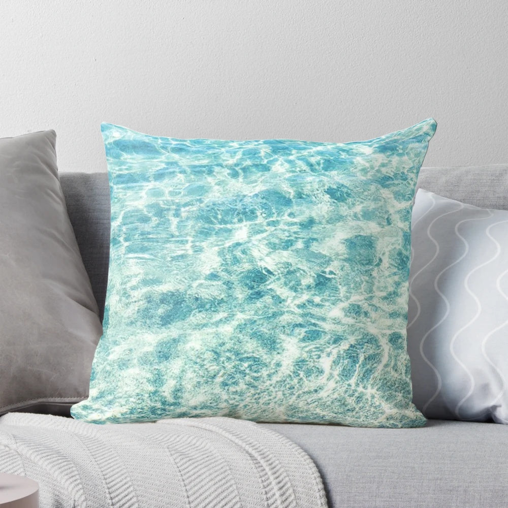A plush, blue water-themed pillow that invites you to escape to a tropical paradise
