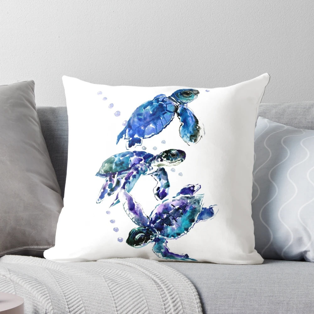 Watercolor painting of three sea turtles swimming in a blue and purple underwater scene, printed on a soft, decorative pillow.