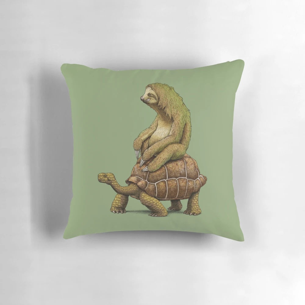 A pillow featuring a sloth and turtle relaxing together in an earth-toned design