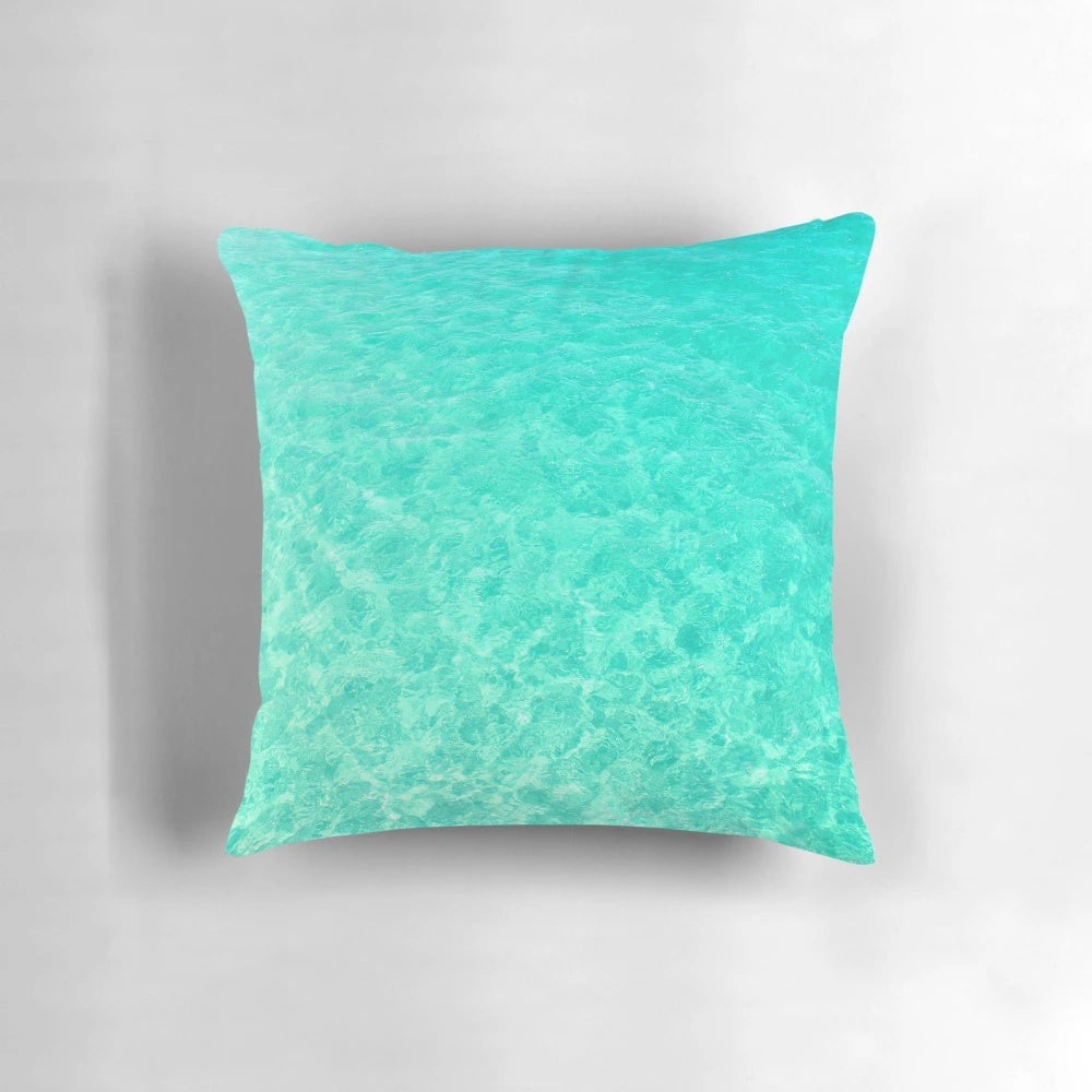 Turquoise and blue ocean waves crashing on a tropical beach, printed on a plush pillow