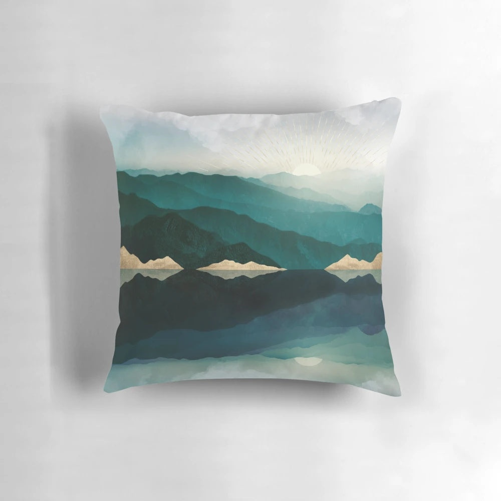 Pillow featuring a serene water reflection landscape in shades of blue, teal, and gold