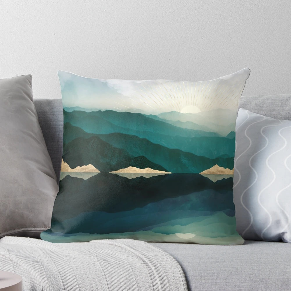 Pillow featuring a serene water reflection landscape in shades of blue, teal, and gold