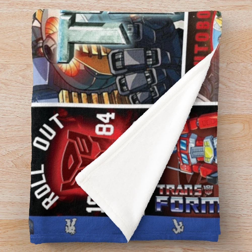 Transformers-inspired plush blanket featuring characters and symbols from the cartoon and movie