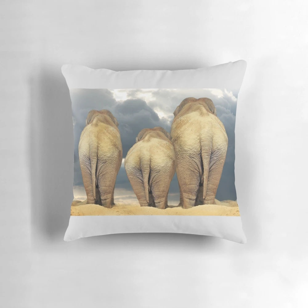 Decorative throw pillow featuring a family of elephants in the African wilderness