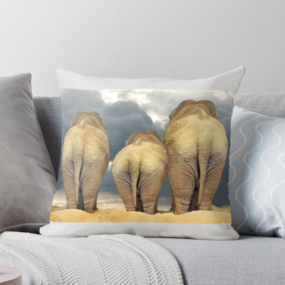 Decorative throw pillow featuring a family of elephants in the African wilderness