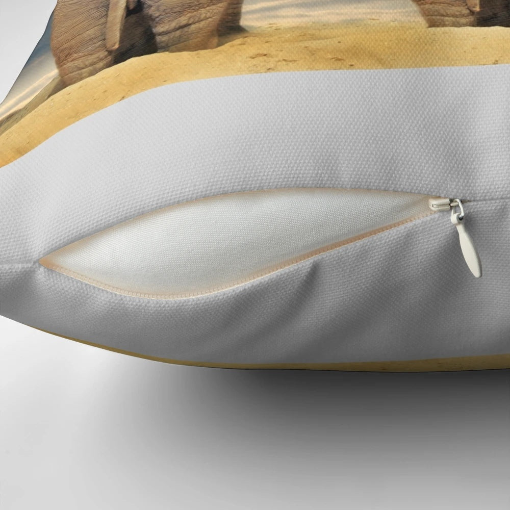 Decorative throw pillow featuring a family of elephants in the African wilderness