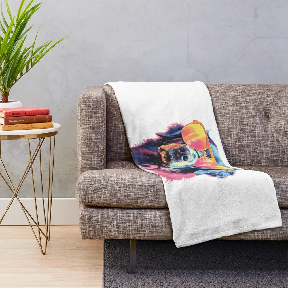 Stylish dog in sunglasses sitting on a colorful, fluffy plush blanket