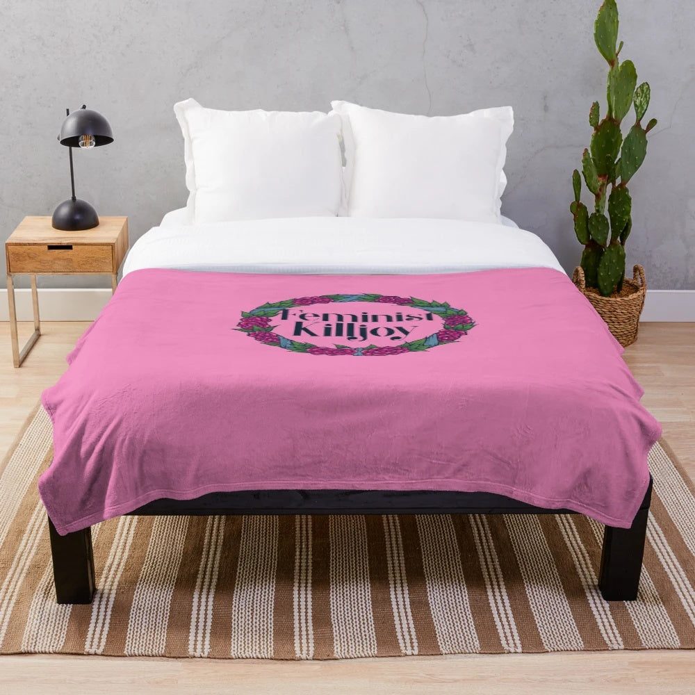 Feminist Killjoy plush blanket with a floral wreath design