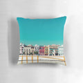 A decorative pillow featuring a stunning cityscape of Triana, Seville, Spain with a blue sky, trees, and houses.