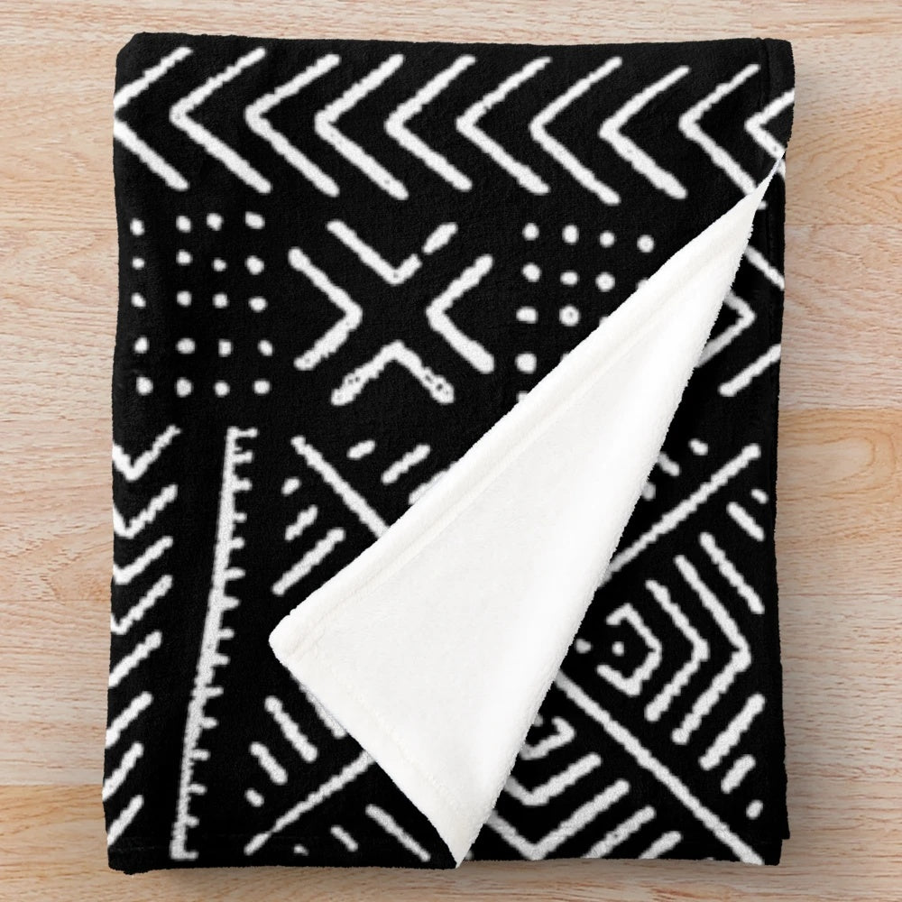 Black plush blanket with mud cloth inspired tribal pattern