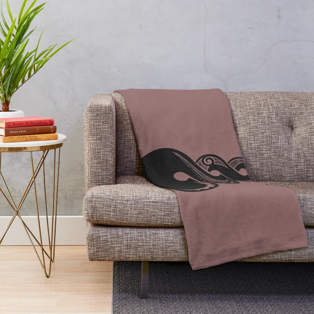 Maori-inspired plush blanket with tribal koru and hei matau pendant design