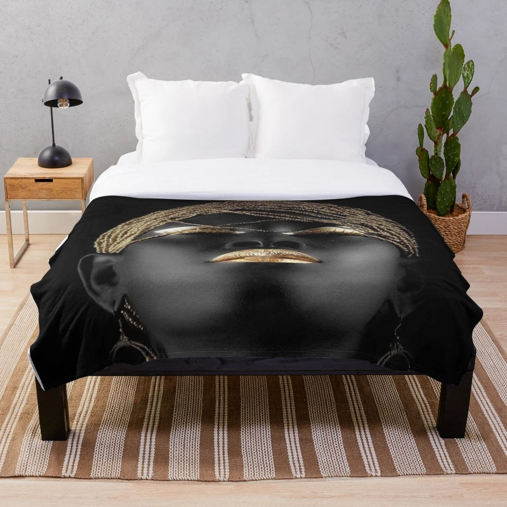 Tribal queen plush blanket with abstract black, gold, and cultural elements