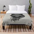 Tribal-inspired plush blanket featuring a silhouette of a legendary bear