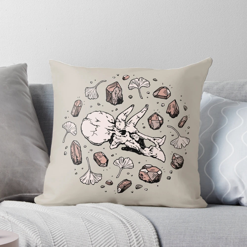 Decorative Triceratops dinosaur skull fossil art pillow with rose quartz mineral accent.