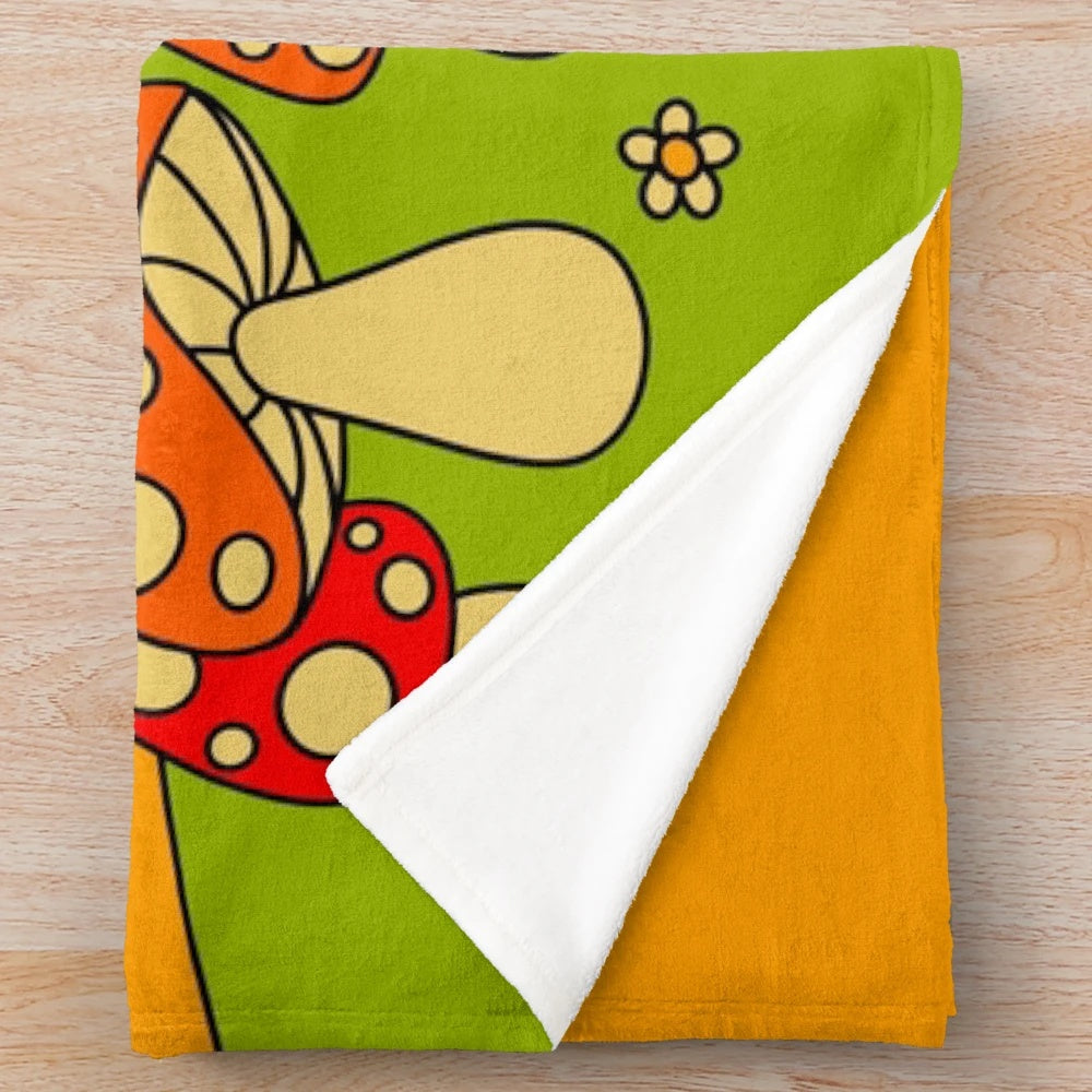 Soft, cozy plush blanket featuring a vibrant mushroom design in psychedelic colors
