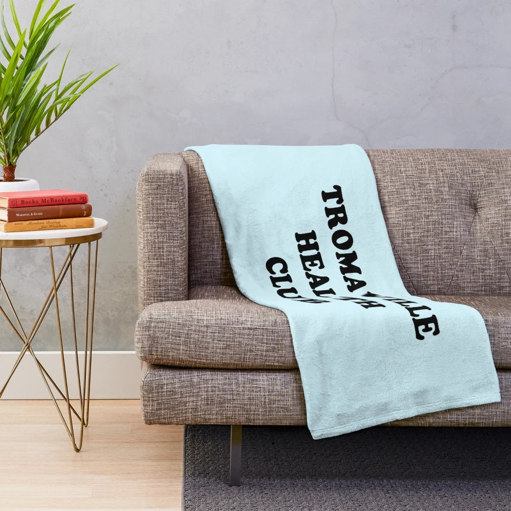 Troma-inspired plush blanket with cult movie graphics