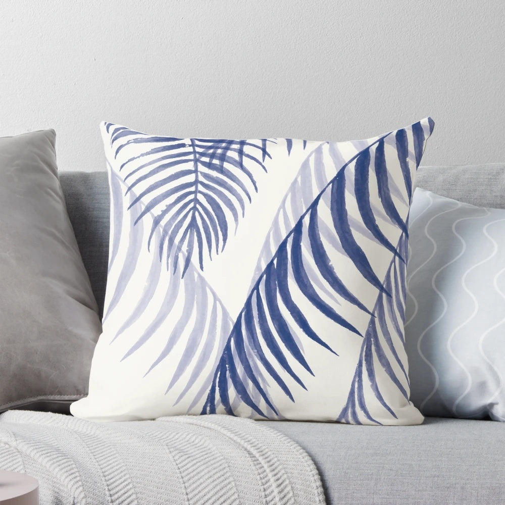 A decorative pillow featuring a vibrant tropical blue leaf pattern, perfect for adding a touch of nature-inspired style to any space.