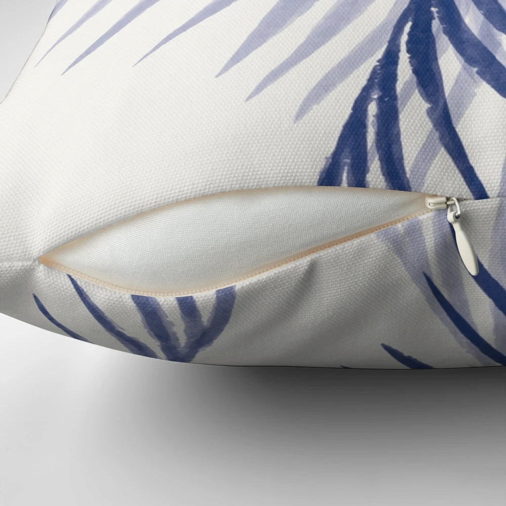 A decorative pillow featuring a vibrant tropical blue leaf pattern, perfect for adding a touch of nature-inspired style to any space.