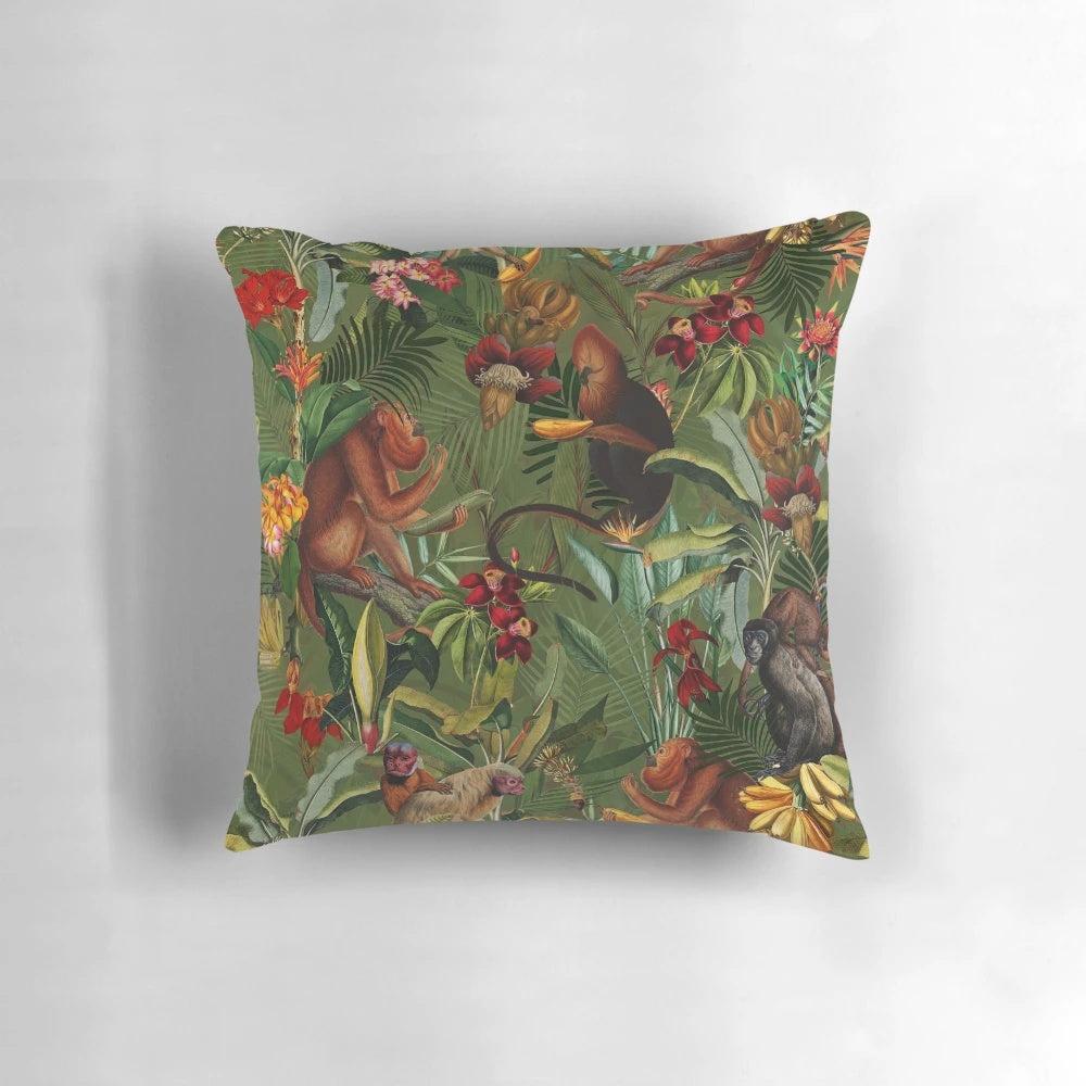 Decorative pillow with a tropical monkey jungle pattern in dark green and botanical floral design.