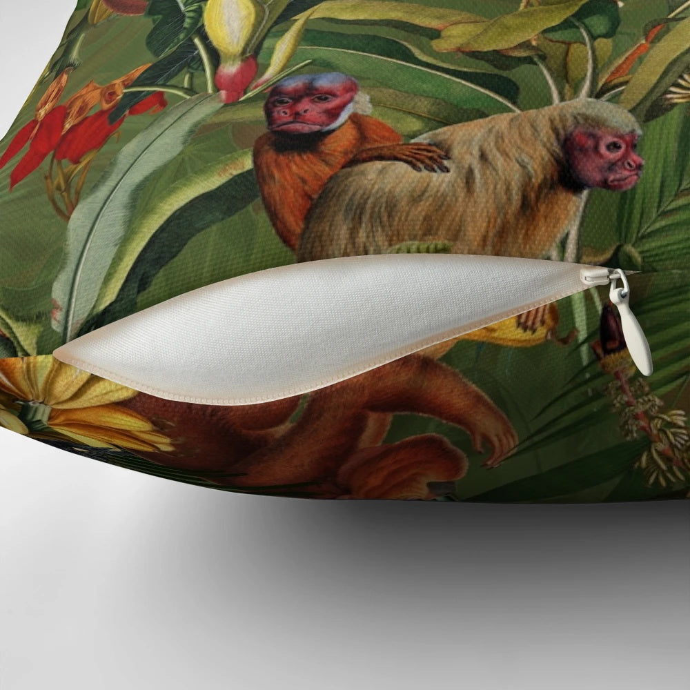 Decorative pillow with a tropical monkey jungle pattern in dark green and botanical floral design.