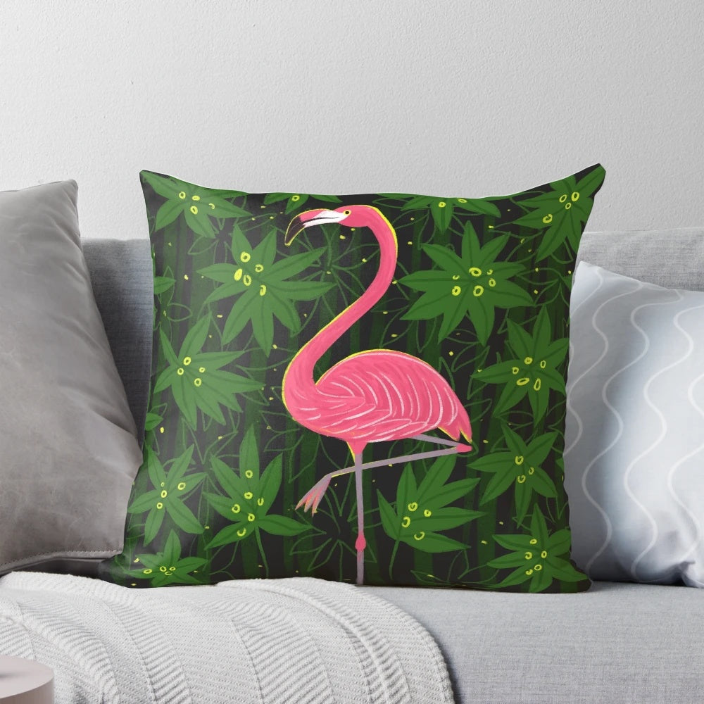 Vibrant pink flamingo print on a tropical leaf patterned decorative pillow