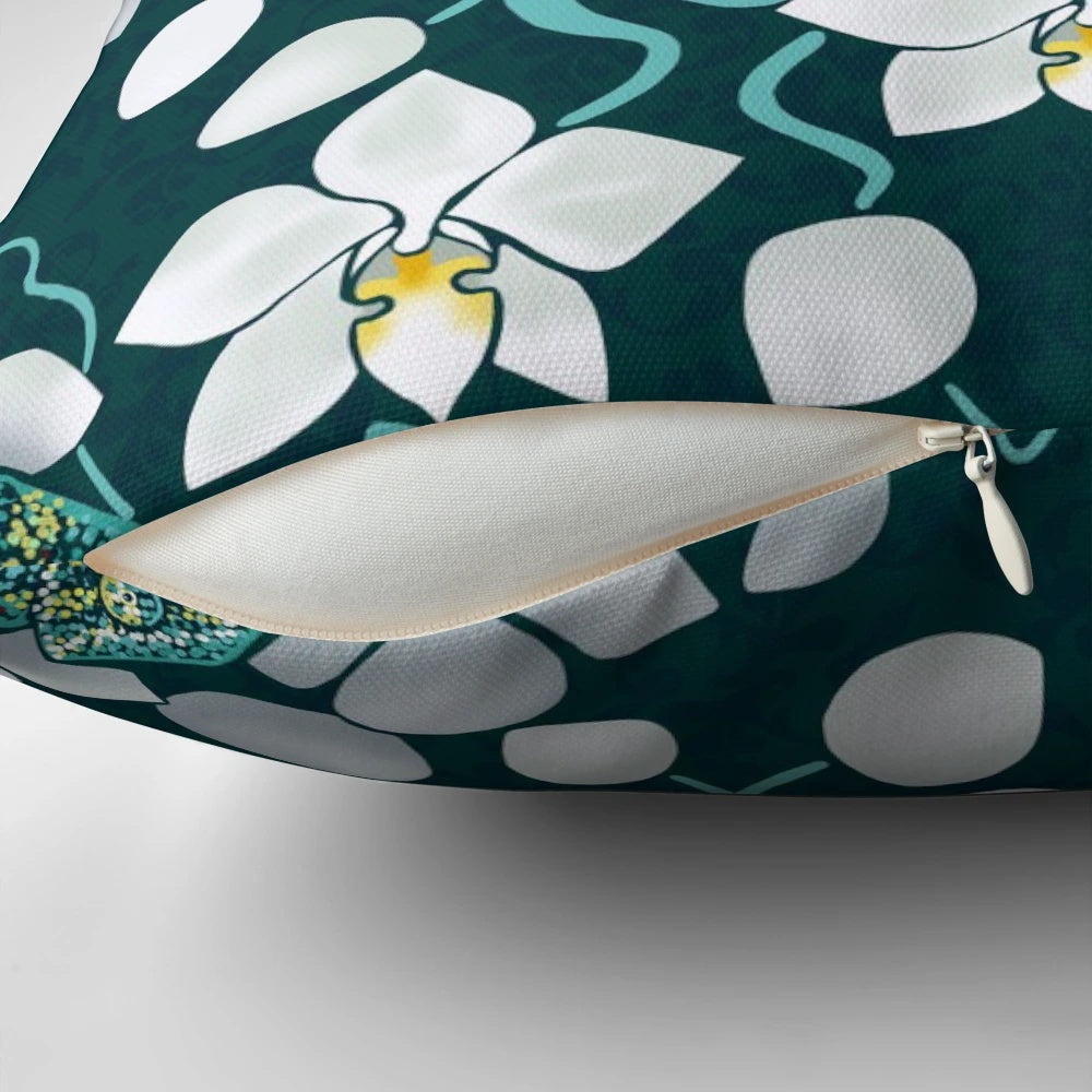 Vibrant tropical floral pillow featuring white orchids and lush greenery