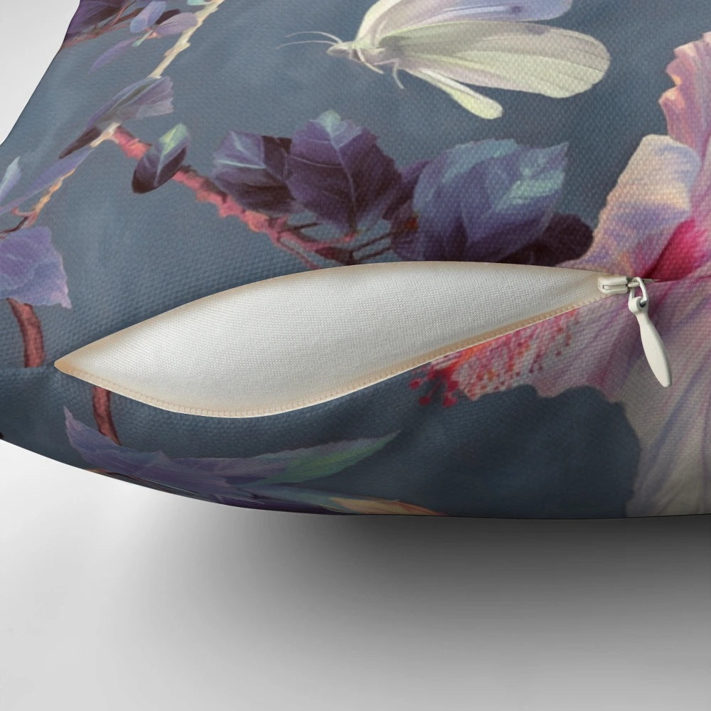 Decorative throw pillow featuring a painted pattern of tropical hibiscus flowers and butterflies in shades of pink, grey, and white.