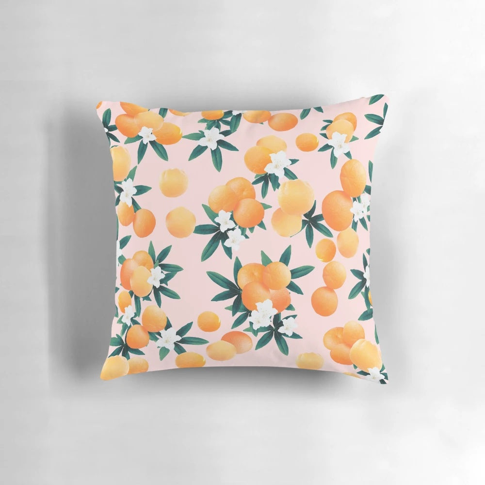 Vibrant orange and green botanical pattern pillow with tropical fruit and floral designs