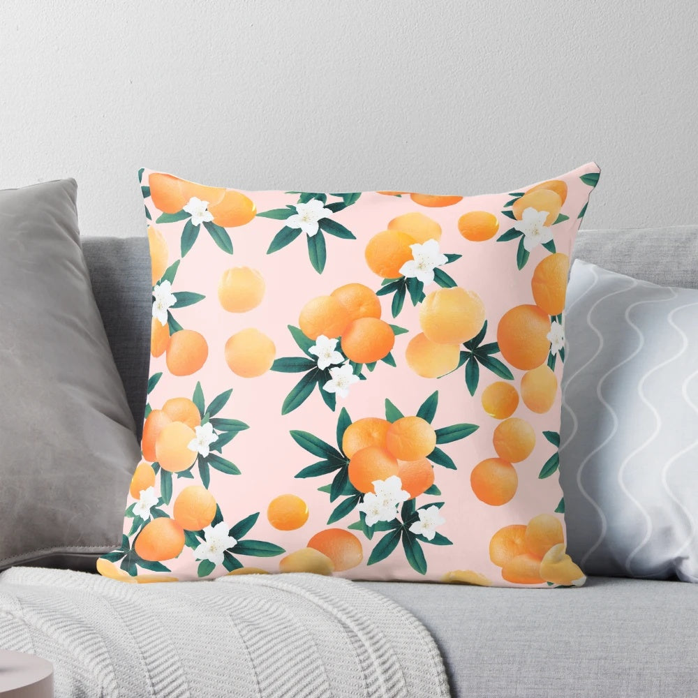 Vibrant orange and green botanical pattern pillow with tropical fruit and floral designs