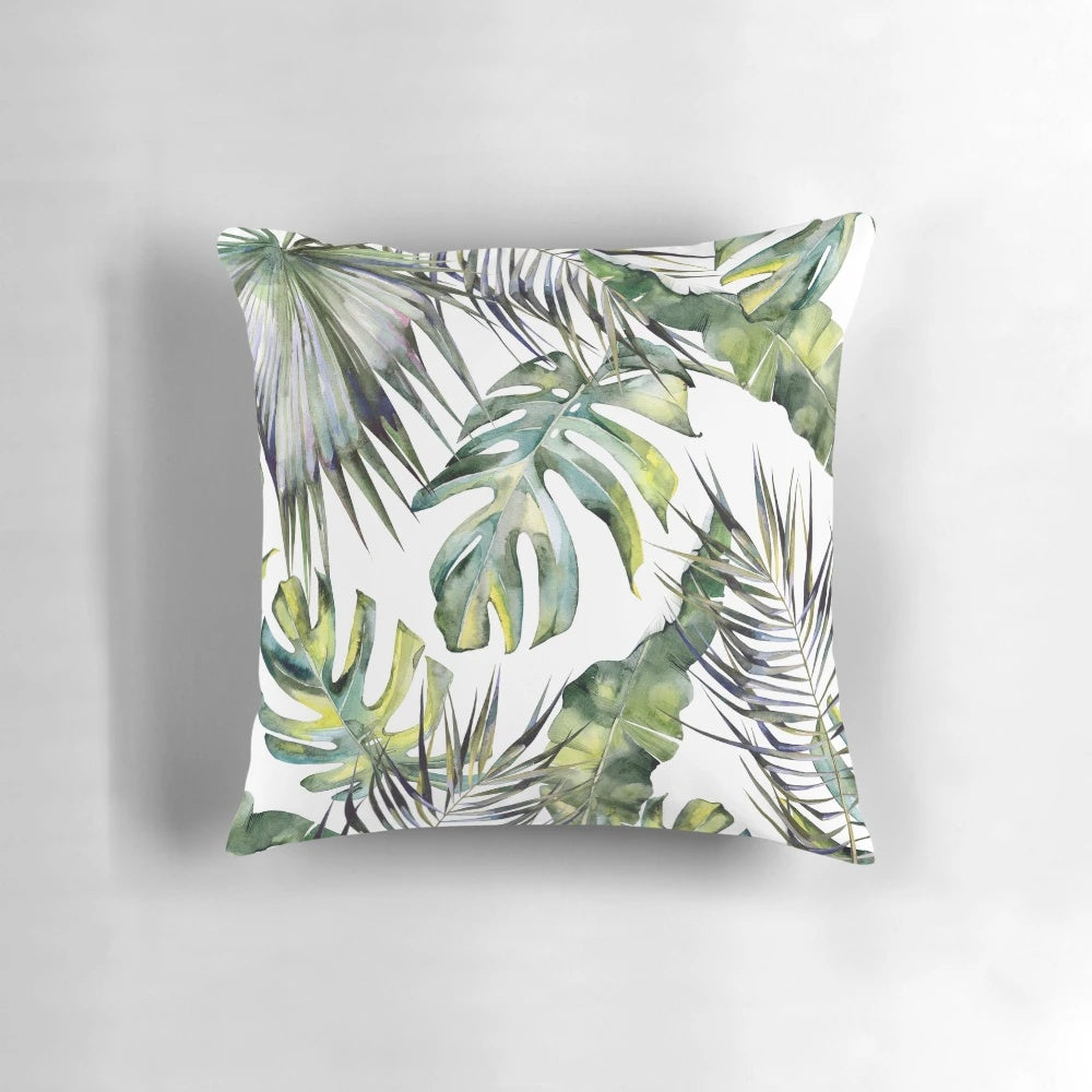 Vibrant tropical garden-inspired botanical pillow with watercolor leaves, bird of paradise, and other lush foliage elements.