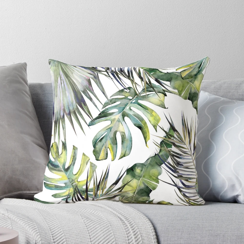 Vibrant tropical garden-inspired botanical pillow with watercolor leaves, bird of paradise, and other lush foliage elements.