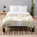 Luxurious gold palm leaves plush blanket for a relaxing, tropical-inspired home