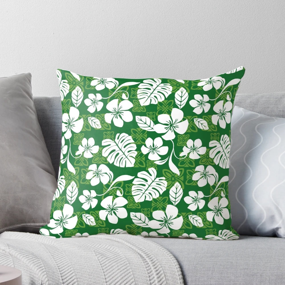 Vibrant tropical Hawaiian flowers and leaves pattern printed on a green and white throw pillow for home decor.