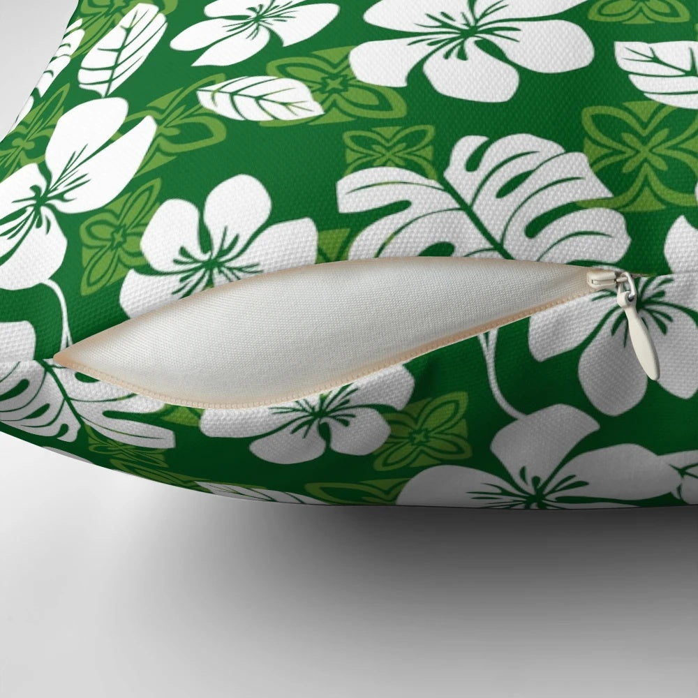 Vibrant tropical Hawaiian flowers and leaves pattern printed on a green and white throw pillow for home decor.