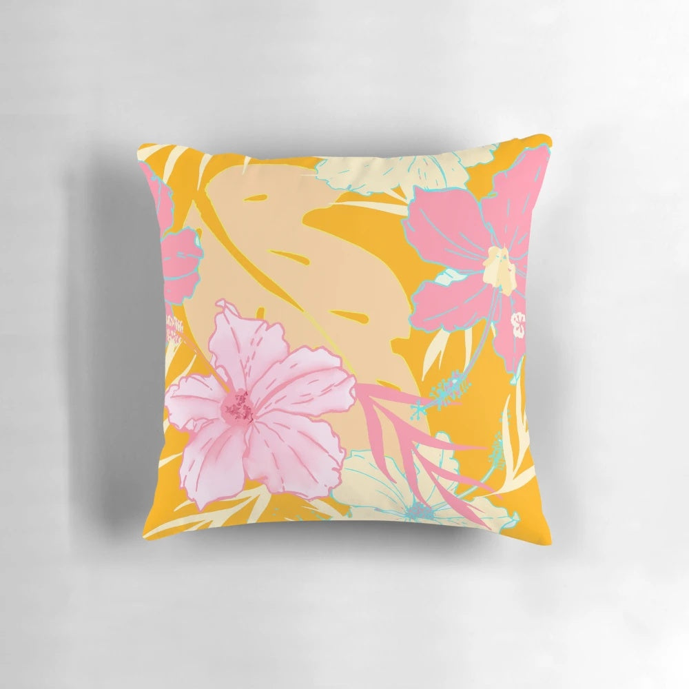 Tropical island-inspired pillow with hibiscus flowers and monstera leaves in a pastel pink and orange watercolor pattern.
