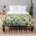 Tropical plush blanket with sunrise colors, floral leaf patterns, and island inspired tribal motifs