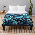 Plush blanket featuring a polynesian-inspired floral and tropical leaf design