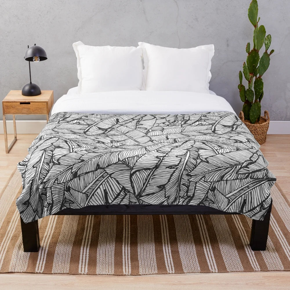 Black and white plush blanket with tropical jungle pattern