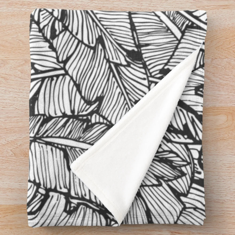 Black and white plush blanket with tropical jungle pattern