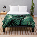 Tropical leaf collage plush blanket featuring vibrant botanical art