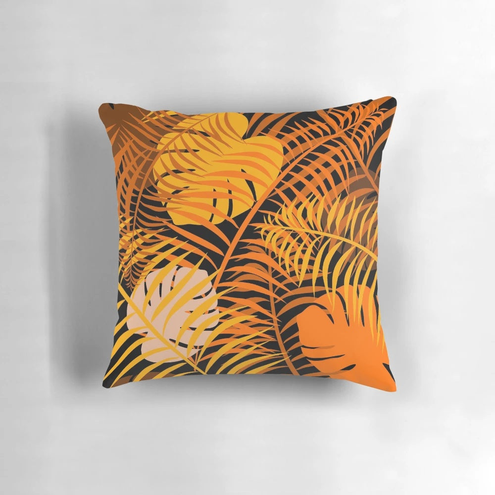 Tropical leaf pattern printed on a burnt orange pillow