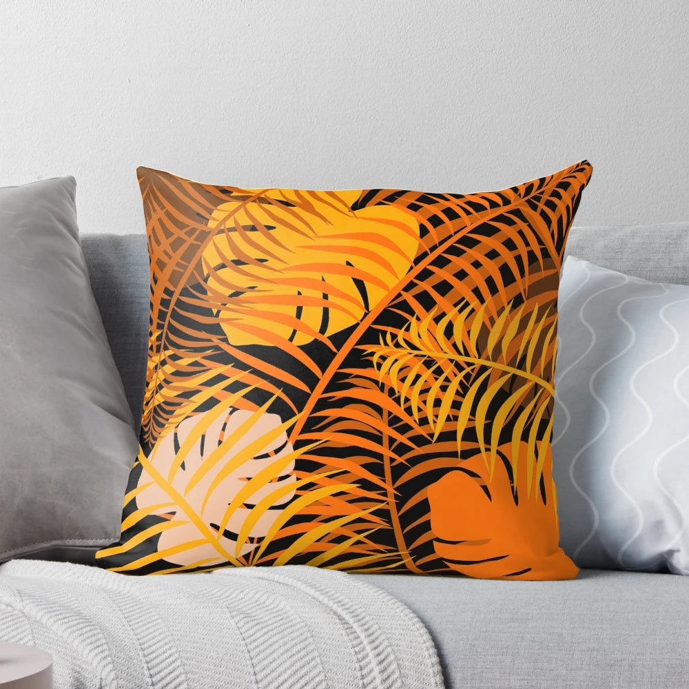 Tropical leaf pattern printed on a burnt orange pillow