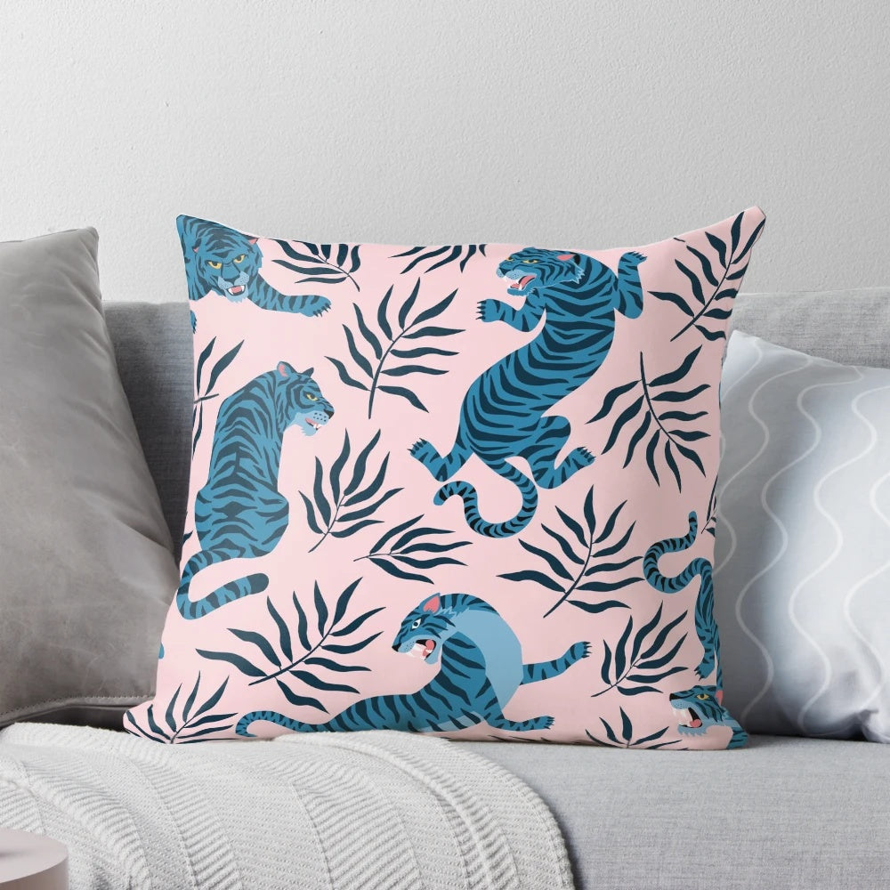 Vibrant tropical leaves and majestic Asian tigers printed on a decorative pillow for a stylish home accent.