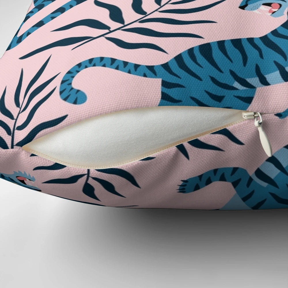Vibrant tropical leaves and majestic Asian tigers printed on a decorative pillow for a stylish home accent.