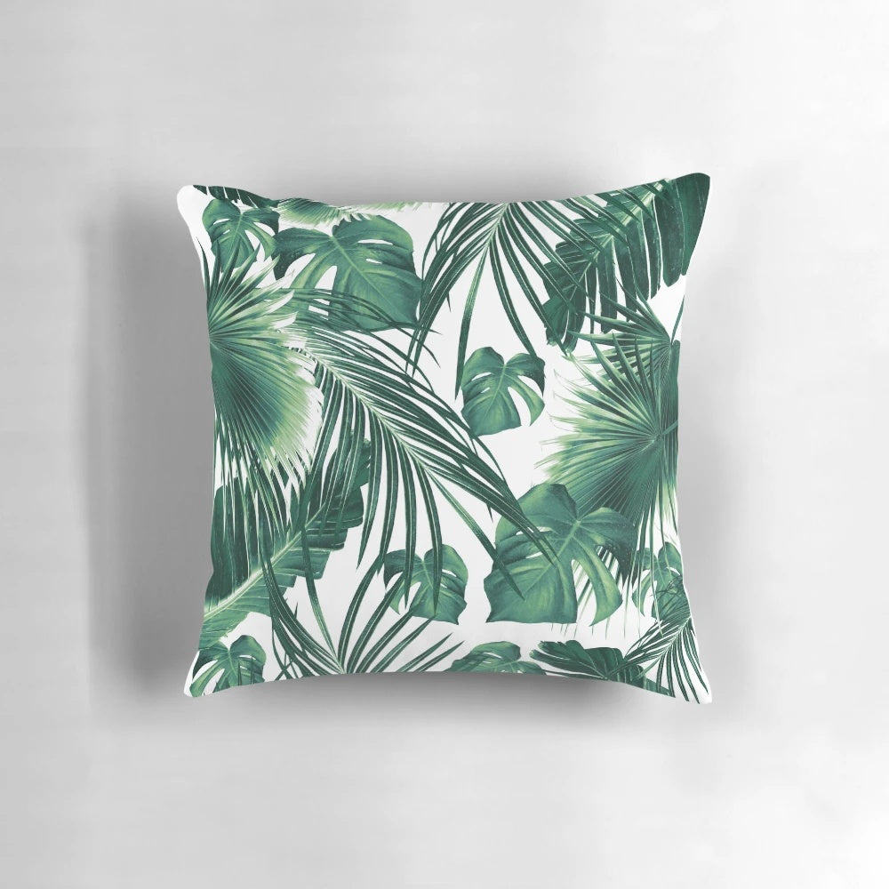 Vibrant tropical leaves collage artwork printed on a soft, high-quality pillow.