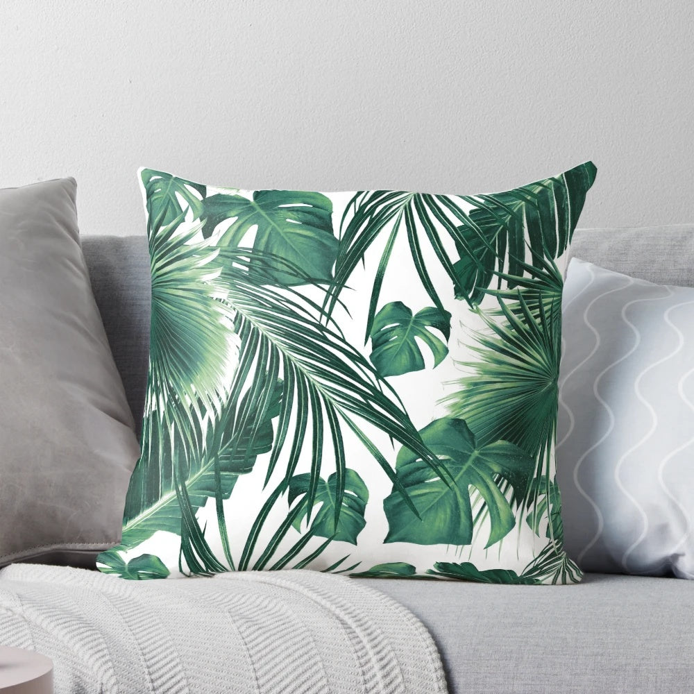 Vibrant tropical leaves collage artwork printed on a soft, high-quality pillow.