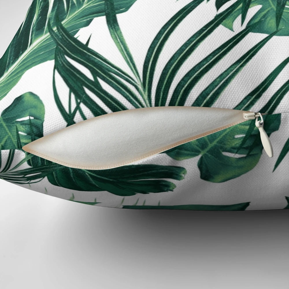 Vibrant tropical leaves collage artwork printed on a soft, high-quality pillow.