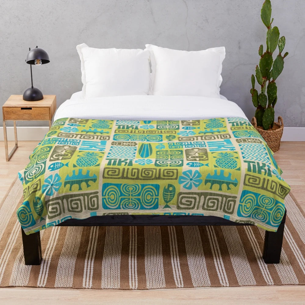 Tropical plush blanket with tiki, surfboard, and pineapple patterns